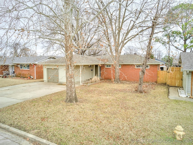 ranch-style house featuring a garage and a front lawn