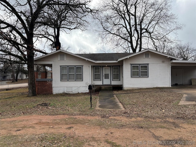 ranch-style home featuring a carport