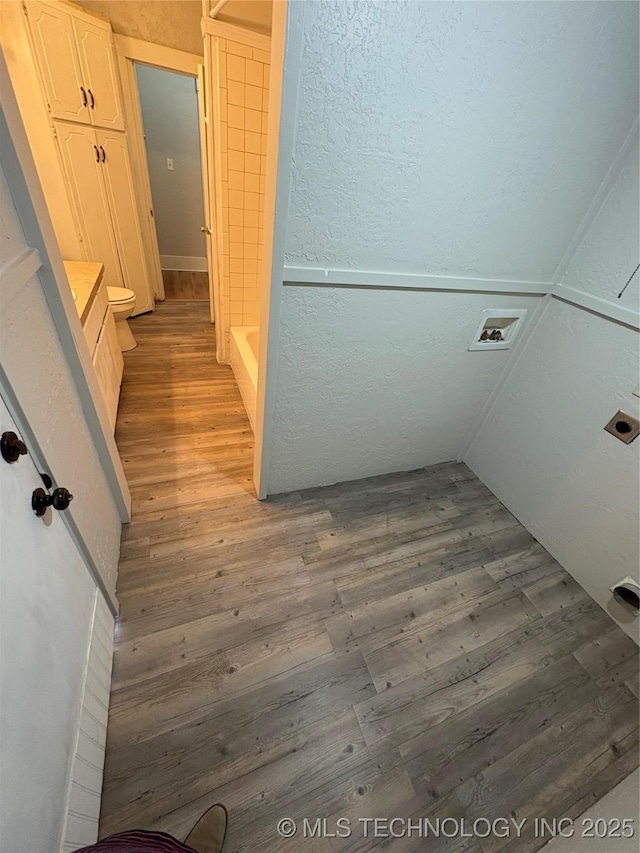 bathroom featuring vanity, toilet, and hardwood / wood-style floors