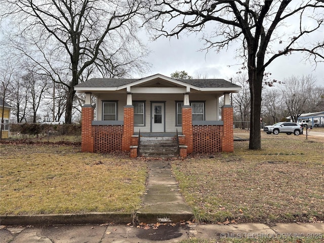 bungalow-style house with covered porch and a front lawn