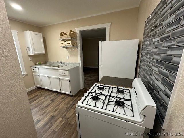 kitchen featuring sink, white appliances, white cabinetry, ornamental molding, and dark hardwood / wood-style flooring