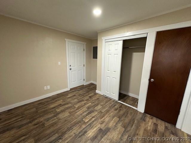 unfurnished bedroom with ornamental molding and dark hardwood / wood-style flooring