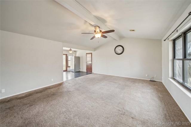 empty room featuring dark carpet, ceiling fan, and vaulted ceiling with beams