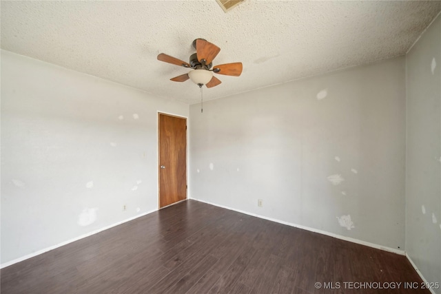 unfurnished room featuring ceiling fan, dark hardwood / wood-style floors, and a textured ceiling