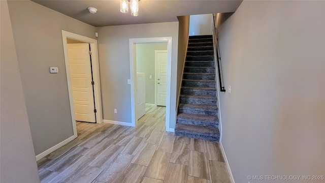 stairs with hardwood / wood-style floors