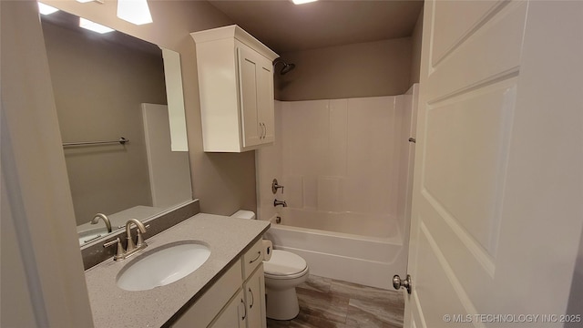 full bathroom featuring shower / bathing tub combination, vanity, and toilet