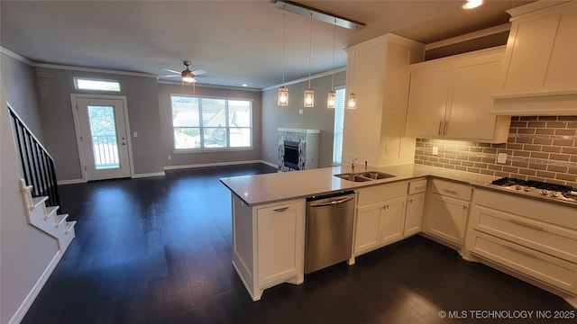 kitchen featuring pendant lighting, premium range hood, white cabinetry, stainless steel appliances, and kitchen peninsula