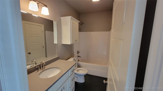 full bathroom with vanity, washtub / shower combination, and toilet