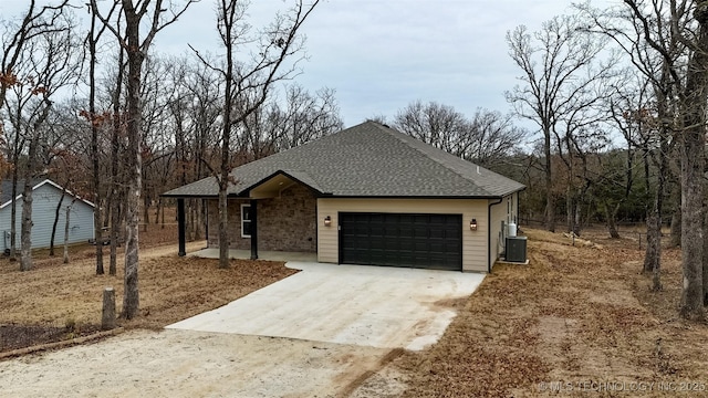 view of front of property with central AC and a garage