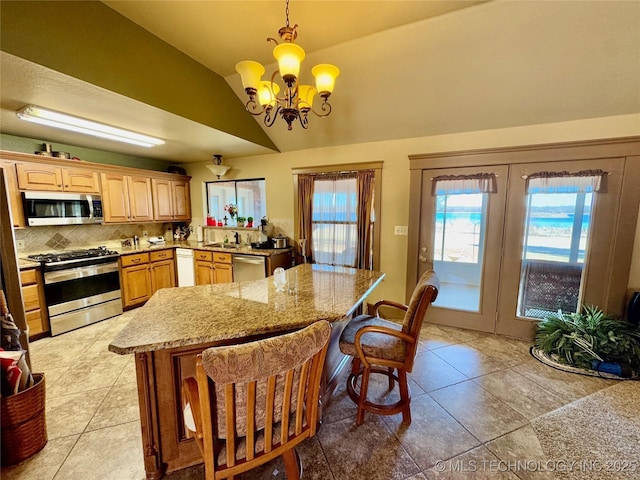 3 Huntly, Burneyville, OK 73430 - kitchen featuring an inviting chandelier, a kitchen breakfast bar, stainless steel appliances, light tile patterned flooring, and lofted ceiling