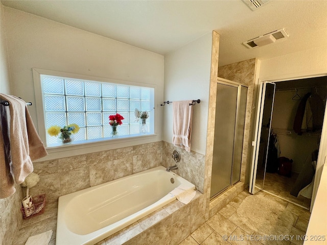3 Huntly, Burneyville, OK 73430 - full bath featuring a walk in closet, a stall shower, a bath, and visible vents