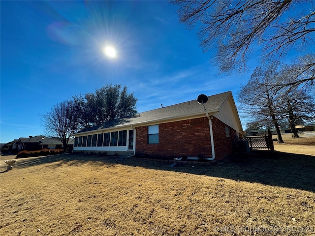 3 Huntly, Burneyville, OK 73430 - view of home's exterior with a yard, brick siding, and a sunroom