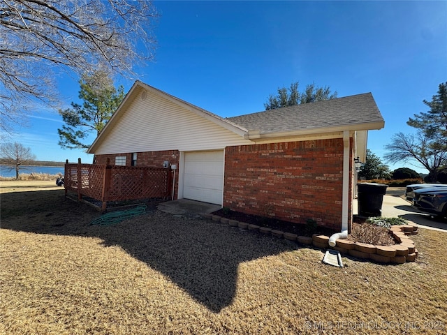 3 Huntly, Burneyville, OK 73430 - view of home's exterior with brick siding, an attached garage, and a shingled roof