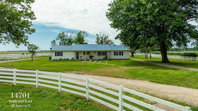 ranch-style house featuring a front yard and a rural view