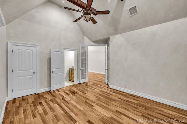 unfurnished bedroom featuring light hardwood / wood-style flooring, high vaulted ceiling, and ceiling fan