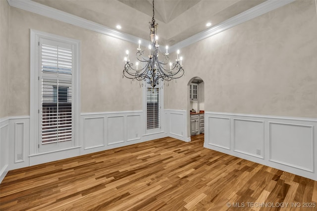 unfurnished dining area with crown molding and light hardwood / wood-style flooring