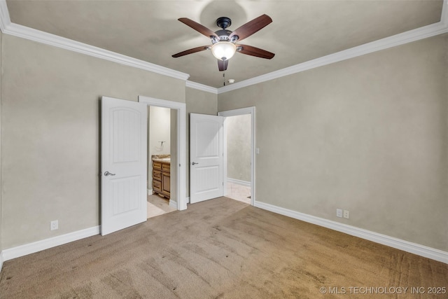 unfurnished bedroom featuring crown molding, connected bathroom, light colored carpet, and ceiling fan