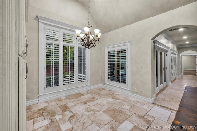 unfurnished dining area with crown molding and an inviting chandelier