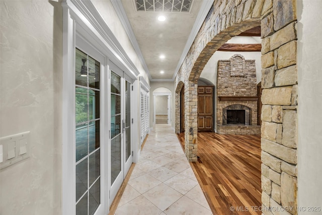 corridor with crown molding and light wood-type flooring