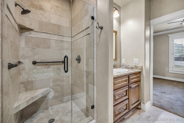 bathroom with vanity, an enclosed shower, crown molding, and tile patterned floors