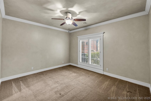 carpeted spare room featuring ceiling fan and ornamental molding