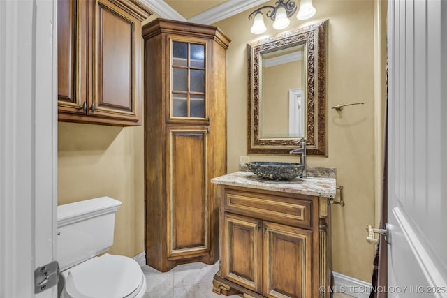 bathroom featuring tile patterned flooring, vanity, crown molding, and toilet