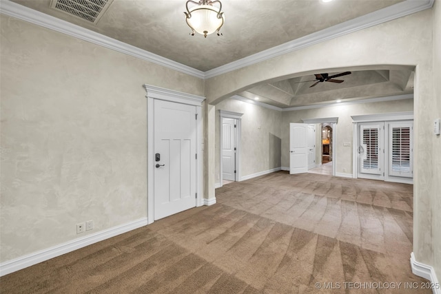 carpeted spare room featuring ceiling fan and ornamental molding