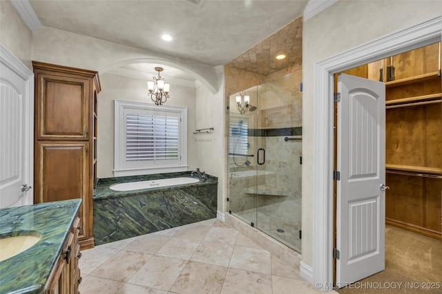 bathroom with vanity, separate shower and tub, ornamental molding, and an inviting chandelier