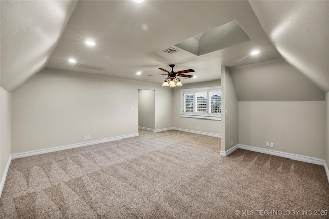 additional living space featuring vaulted ceiling, light colored carpet, and ceiling fan