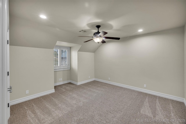 additional living space with light carpet, lofted ceiling, and ceiling fan