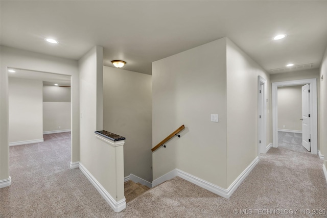 hallway with light colored carpet