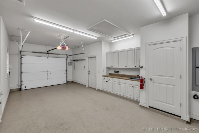 garage featuring a garage door opener and sink