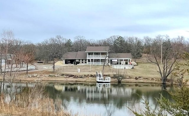 back of property featuring a water view