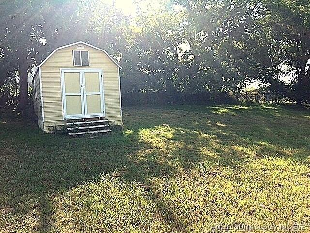 view of outdoor structure with a lawn