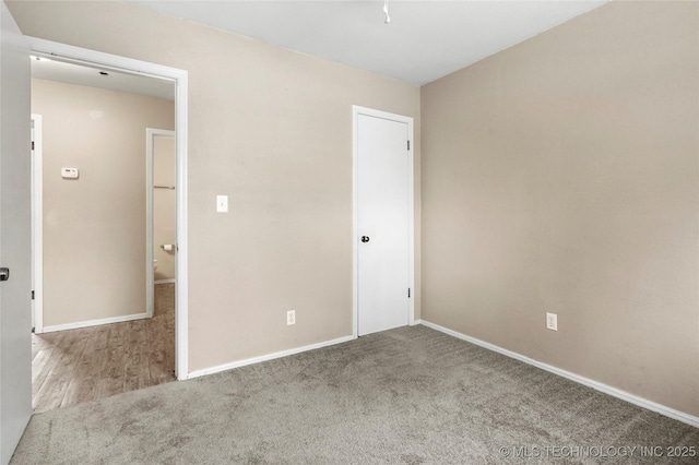 unfurnished bedroom featuring light carpet