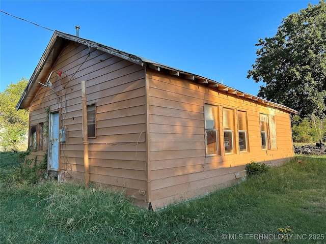 view of property exterior featuring a lawn