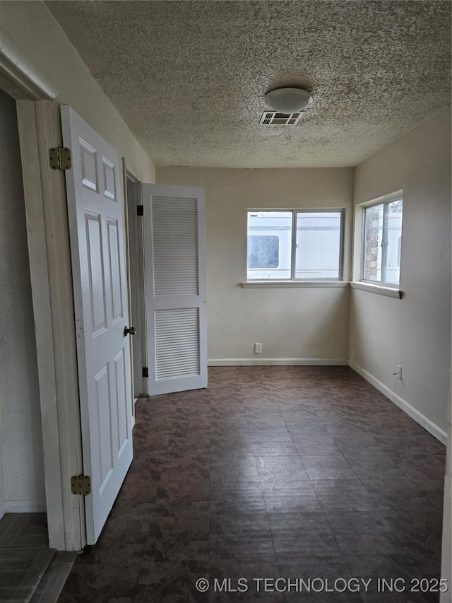 empty room with a textured ceiling