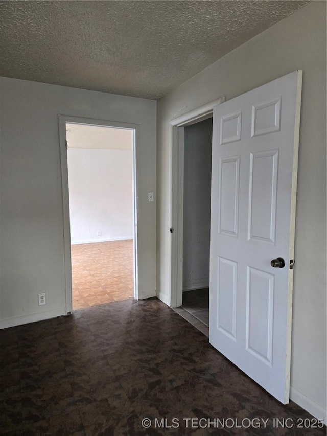 spare room with a textured ceiling