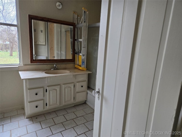 bathroom with tile patterned flooring and vanity