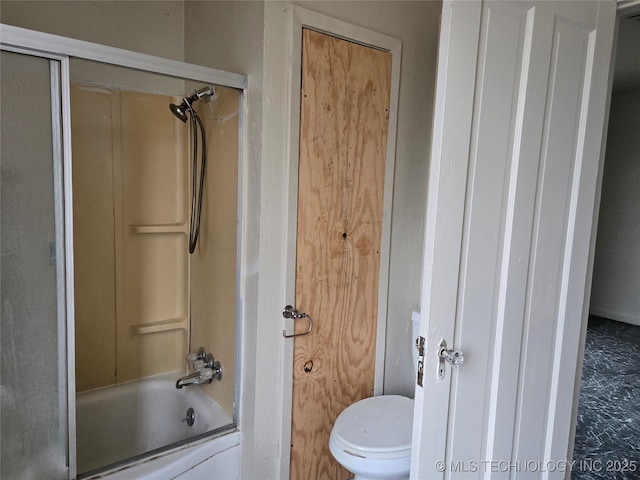 bathroom with enclosed tub / shower combo and toilet