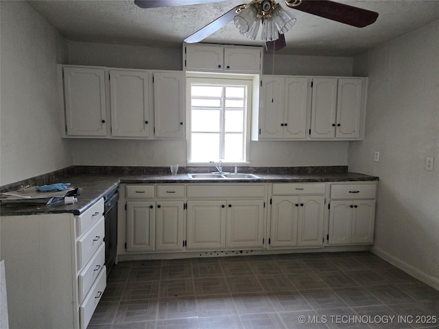 kitchen featuring black dishwasher, sink, white cabinets, and ceiling fan