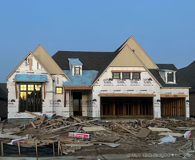 unfinished property with a garage and stucco siding