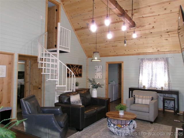 living room with wood ceiling, wooden walls, high vaulted ceiling, and washing machine and clothes dryer