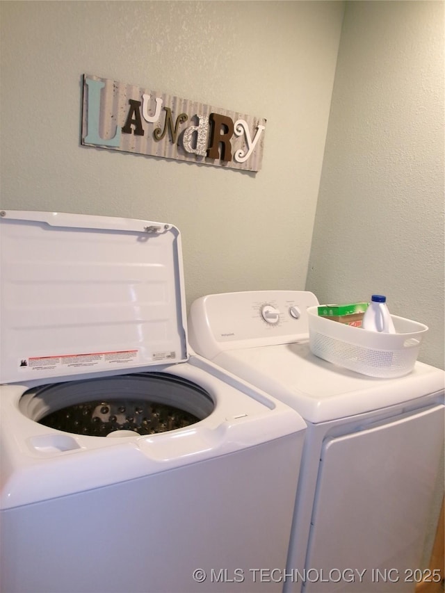 laundry room featuring washing machine and clothes dryer