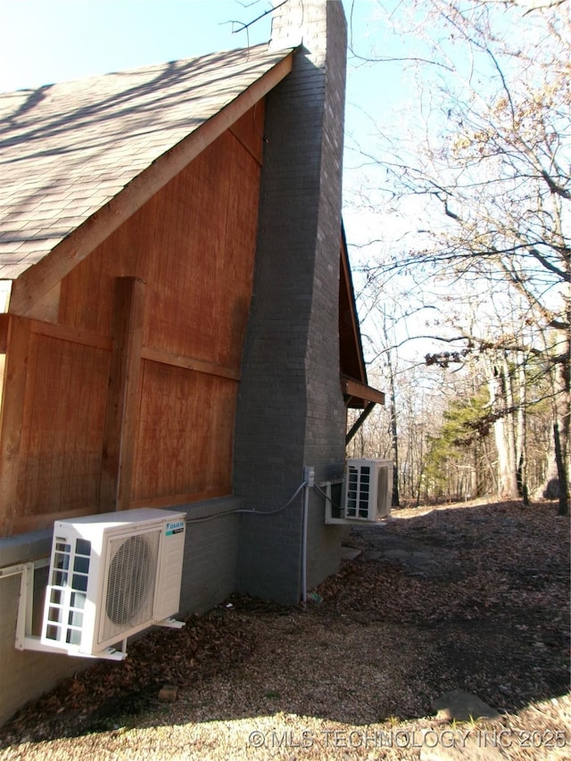 view of side of home featuring ac unit