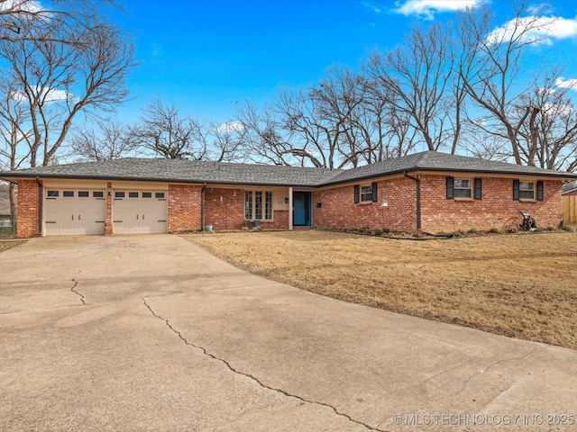 ranch-style house featuring a garage and a front lawn