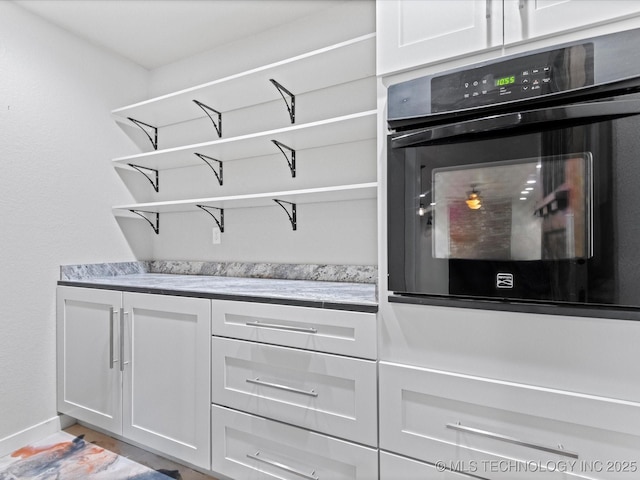 kitchen with wall oven and white cabinets