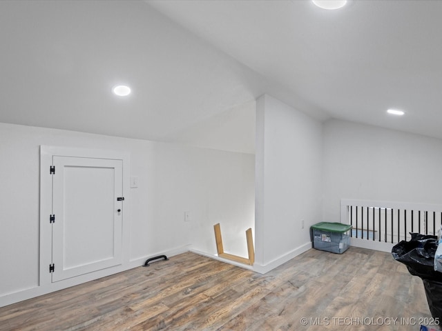 bonus room featuring wood-type flooring and lofted ceiling