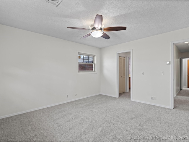 unfurnished room featuring light carpet, a textured ceiling, and ceiling fan