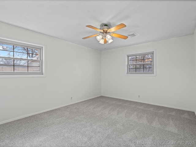 unfurnished room with ceiling fan and carpet flooring